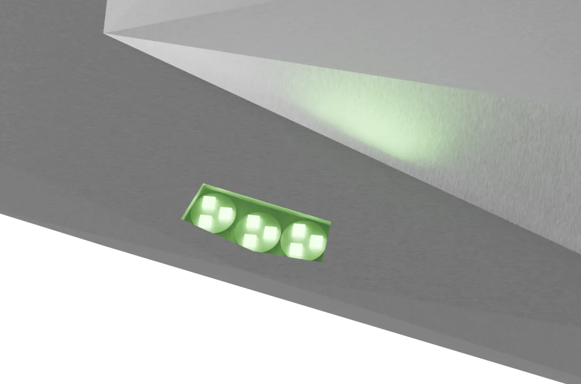 Close-up render of a recessed LED module on Mobula's hull: nine green emitters under three lenses on a green board, throwing a cone of light across the faceted plating